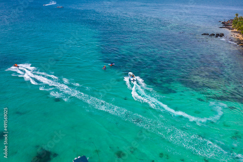 Tourists are playing parasailing game on Phu Quoc island, Vietnam © lochuynh