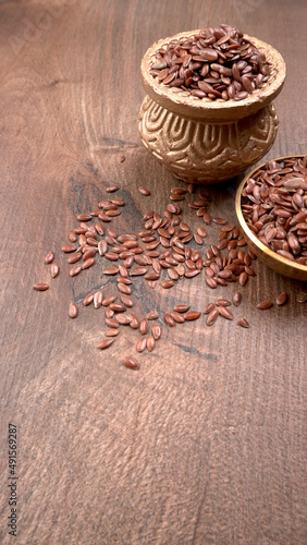Brown flax seed or linseed on wooden background. Diet healthcare healthy food.  © Raksha