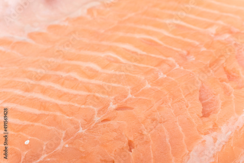 Closeup of a juicy piece of raw salmon fillet, with pink, healthy meat. photo