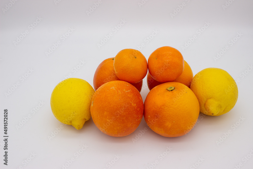 Few oranges, tangerines and lemons on white background. Few oranges, tangerines and lemons on white background.