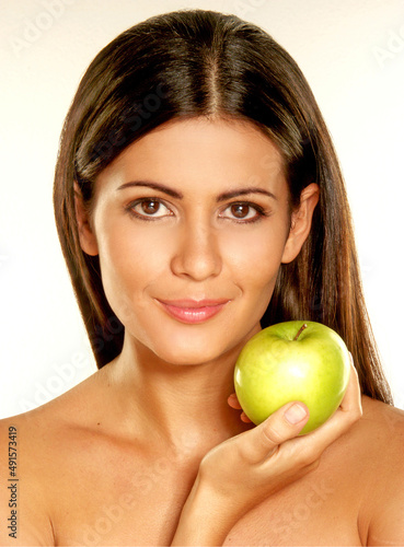 Beautiful young woman holding a green apple fruit