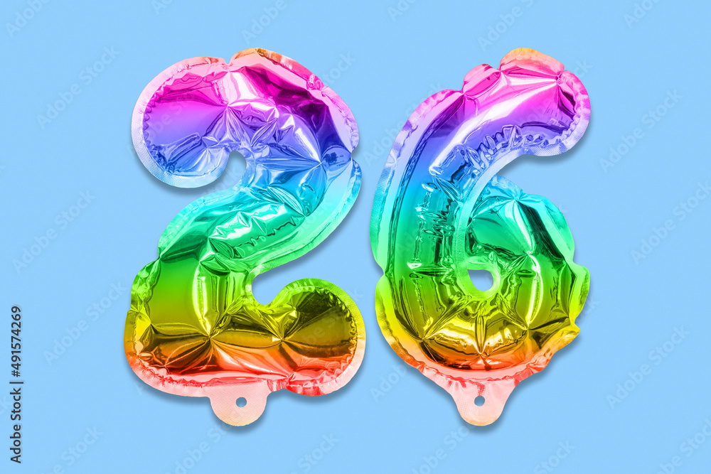 Rainbow foil balloon number, digit twenty six on a blue background. Birthday greeting card with inscription 26. Top view. Numerical digit. Celebration event, template.
