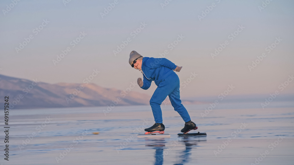 The child train on ice professional speed skating. The girl skates in the winter in sportswear, sport glasses, suit. Children speed skating short long track, kid sport. Outdoor slow motion. The child train on ice professional speed skating. The girl skates in the winter in sportswear, sport glasses, suit. Children speed skating short long track, kid sport. Outdoor slow motion.