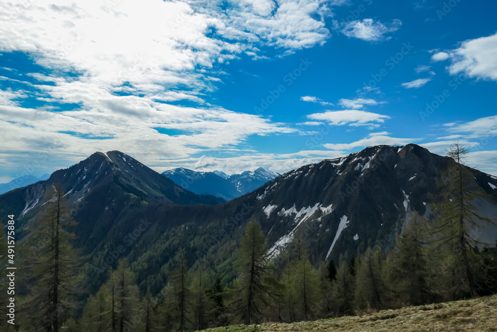 Panoramic view near Frauenkogel on the mountain peaks in the Karawanks, Carinthia, Austria. Borders Austria, Slovenia, Italy. Triglav National Park. Looking on mount Kahlkogel (Golica). Forest valley
