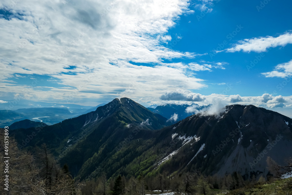 Panoramic view near Frauenkogel on the mountain peaks in the Karawanks, Carinthia, Austria. Borders Austria, Slovenia, Italy. Triglav National Park. Looking on mount Kahlkogel (Golica). Forest valley