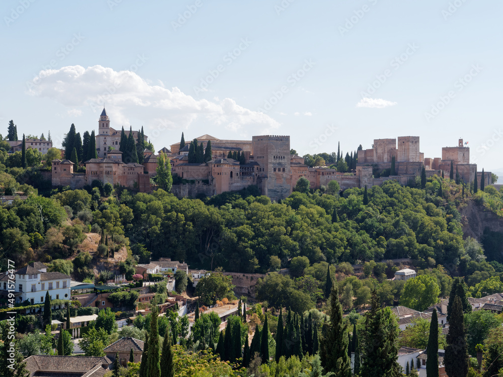 Panoramic view of Alhambra in Granada with the Sacromonte neighborhood below. Moorish Architecture. Unesco Spain. Travel in time and discover history. Amazing destinations for holidays. 
