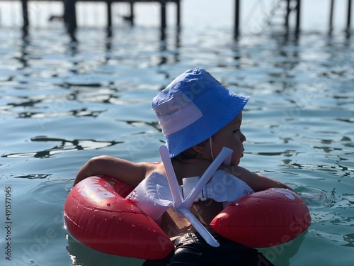 Little kid swimming with Lifebuoy. Summer family holidays. Sea swimming with little boy