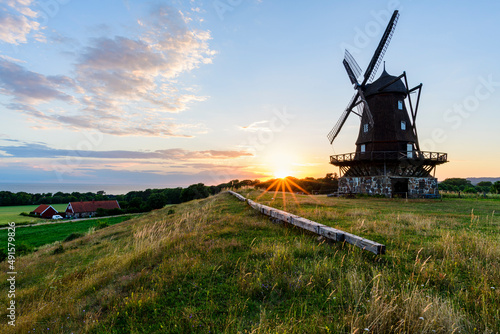 Wooden windmill at sunset photo