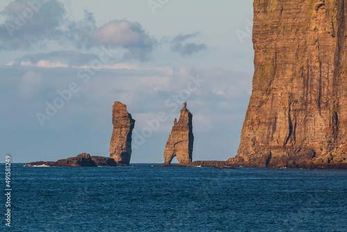 Risin og Kellingin rock formations on the coast of Streymoy Island, Tjornuvik, Faroe Islands, Denmark. photo