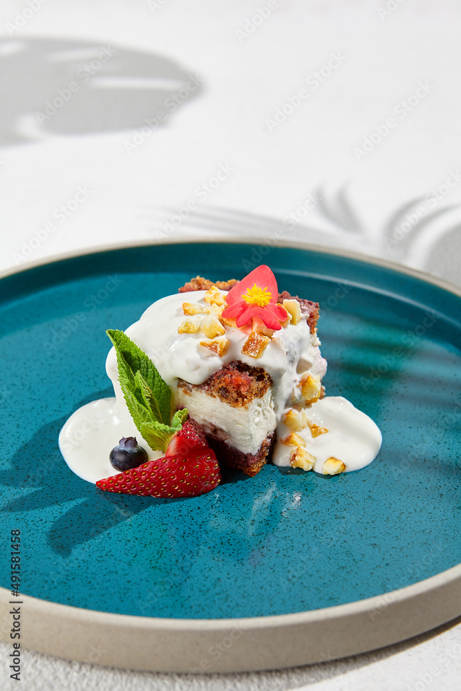 Carrot cake with cream cheese and berries on ceramic plate. Elegant dessert - carrot pie on white background with shadows of leaves. Portion cake on modern plate in minimal style. Carrot cake with cream cheese and berries on ceramic plate. Elegant dessert - carrot pie on white background with shadows of leaves. Portion cake on modern plate in minimal style.