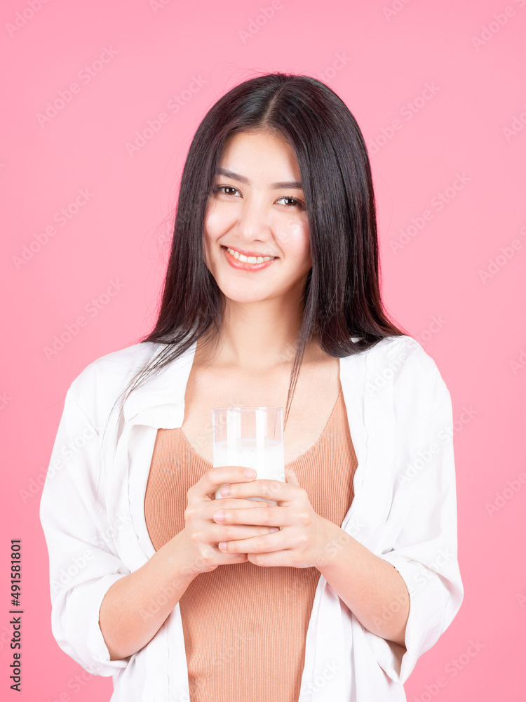 beauty woman Asian cute girl feel happy drinking milk for good health in the morning on pink background - lifestyle beauty woman c beauty woman Asian cute girl feel happy drinking milk for good health in the morning on pink background - lifestyle beauty woman c