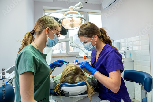 female dentist professional examination of the patient s oral cavity.