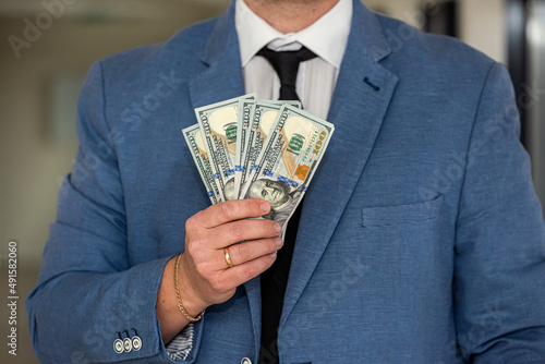 man in suit counting us money dollar