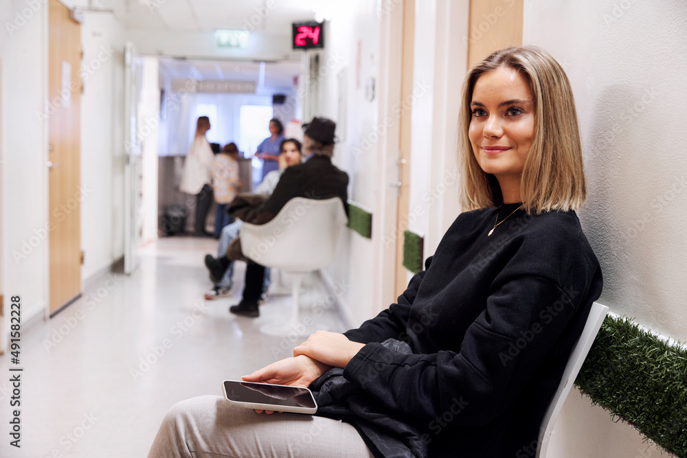 Young female patient waiting in outpatient clinic Young female patient waiting in outpatient clinic