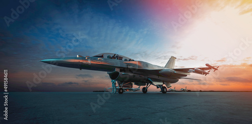 Fotografia military jet aircraft parked on runway in sunset.