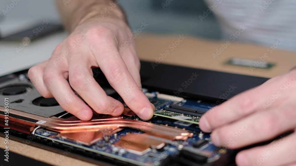 Unrecognizable engineer pulls out the RAM. Electronic renovation, business, occupation concept Unrecognizable engineer pulls out the RAM. Electronic renovation, business, occupation concept