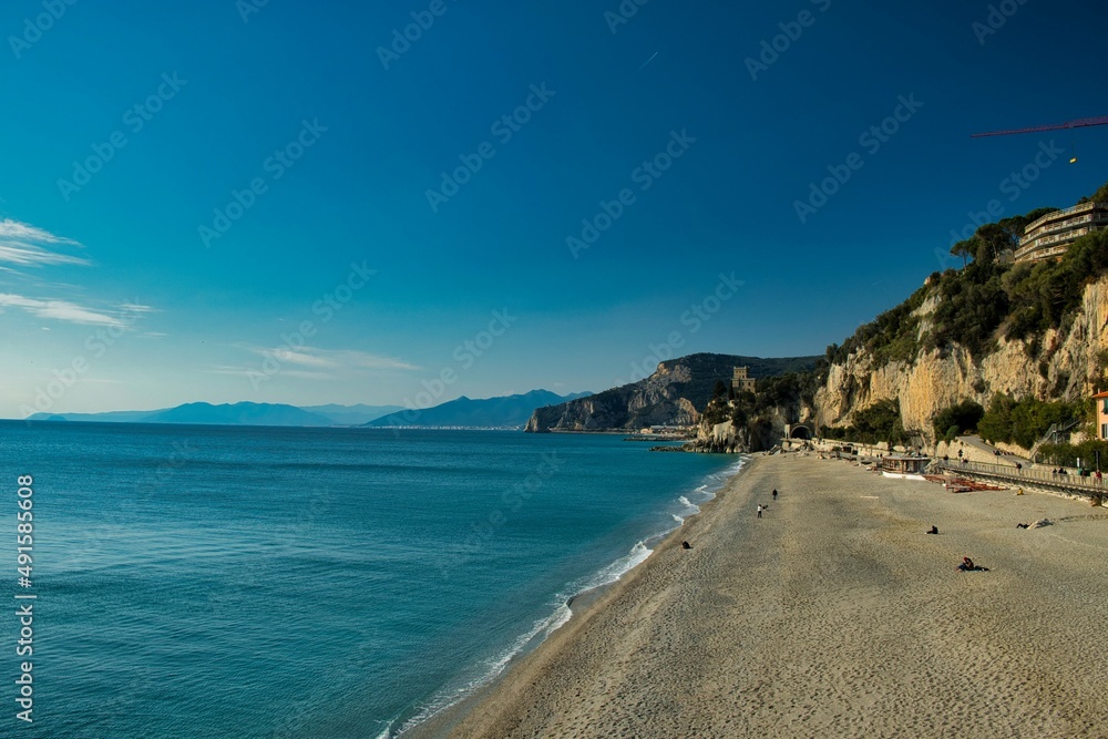 beach of fine sand with the waves of the sea that bathe the coast of western Liguria, in varigotti italy