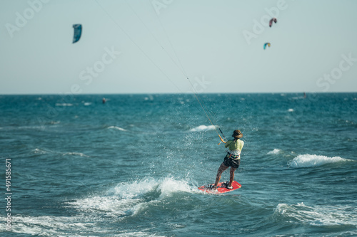 A man is kitesurfing on the sea