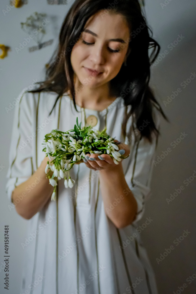 woman in white dress holding shells woman in white dress holding shells