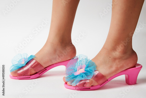 Little girl wearing pink shoes on white background with copy space