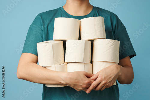 Woman holds toilet paper rolls, close-up