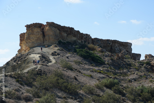 People on the footpath leading up to Il-Qarraba promontory at Ghajn Tuffieha Bay, Malta.