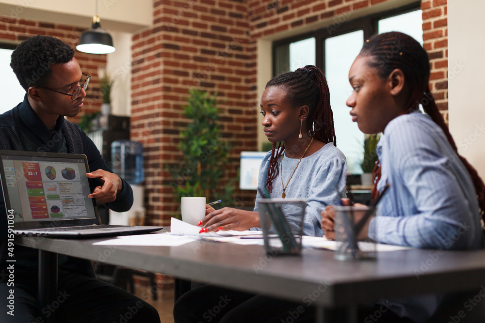 Development department african american team leader informing employees about business plan. Marketing company worker presenting coworkers work policy and new annual expenses budget. Development department african american team leader informing employees about business plan. Marketing company worker presenting coworkers work policy and new annual expenses budget.