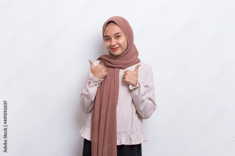 young asian beautiful muslim woman with ok sign gesture tumb up isolated on white background
