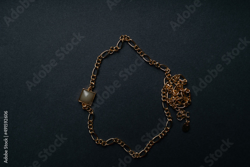 geometrical pendant and golden chain. jewelry on black background. High quality photo