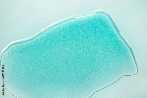 Cosmetic liquid serum or acid peeling or blue hyaluronic acid gel textured background swatch isolated background photo