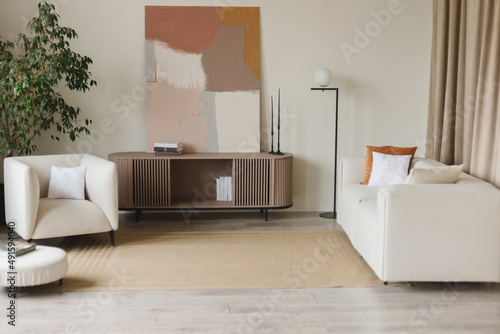 Obraz na płótnie Interior design of stylish living room with modern neutral sofa decoration and elegant personal accessories in home decor. w salonie