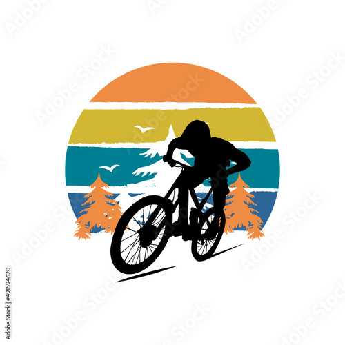 Silhouette mountain biker design with tree background