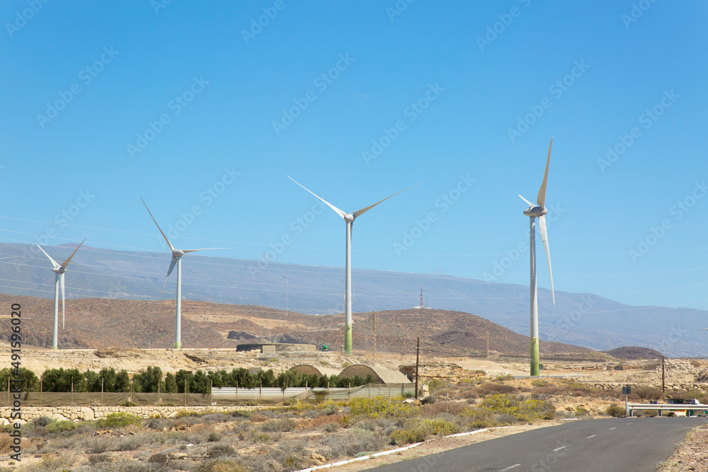 Wind farms, mountains in the background
