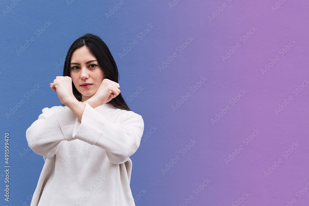 Asian woman unhappy or confident standing, She holding two crossing arms say no X sign Asian woman unhappy or confident standing, She holding two crossing arms say no X sign