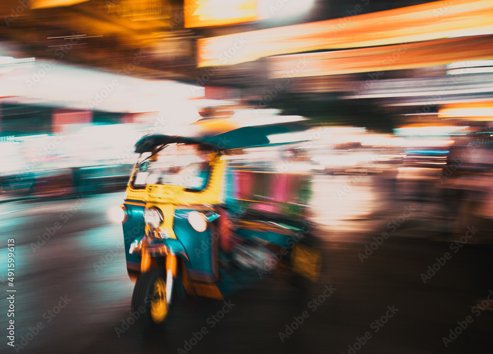 blurred tuk tuk in traffic in Bangkok