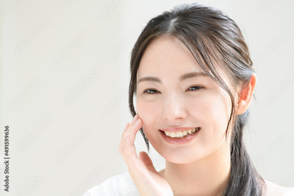 Beautiful Japanese woman with her hands on her face and smile, easy to use for beauty Beautiful Japanese woman with her hands on her face and smile, easy to use for beauty