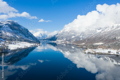 Impressive lake in the austrian alps. Panoramic view of the beautiful mountain landscape with Grundlsee. In the background the massif called dead mountains. Styria, Austria