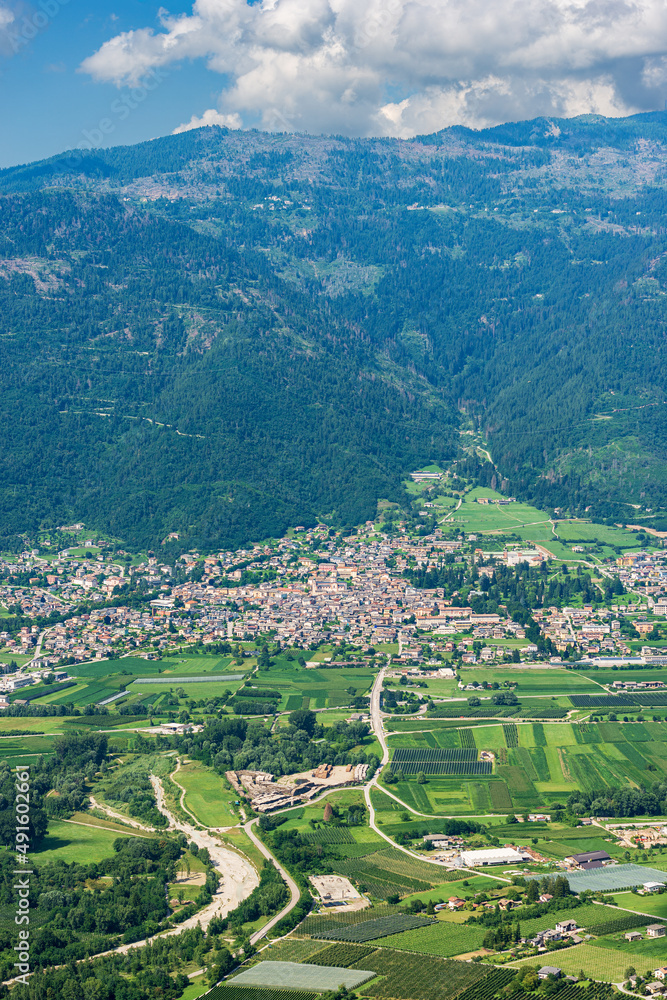 Aerial view of Sugana valley (Valsugana), small town of Levico Terme on the coast of Levico lake and mountain range of Lagorai. Tourist resort in Trento province, Trentino Alto Adige, Italy, Europe.