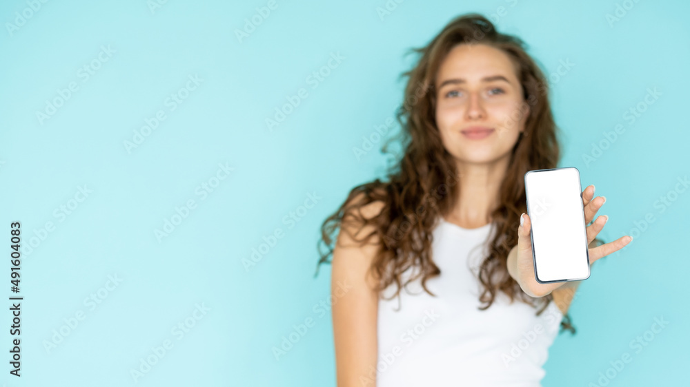 Mobile application. Happy woman. Digital technology. Pretty smiling lady showing smartphone blank screen posing isolated blue copy space. Mobile application. Happy woman. Digital technology. Pretty smiling lady showing smartphone blank screen posing isolated blue copy space.