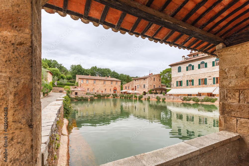 View from Loggiato di S.Caterina to the clean pool of hot mineral spring water in Bagno Vignoni. Tuscany, Italy