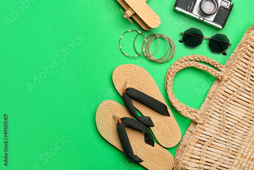 Set of beach accessories on green background