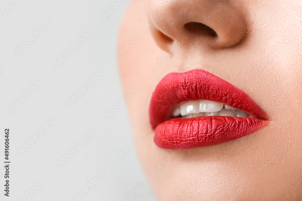 Beautiful woman with red lipstick on light background, closeup Beautiful woman with red lipstick on light background, closeup