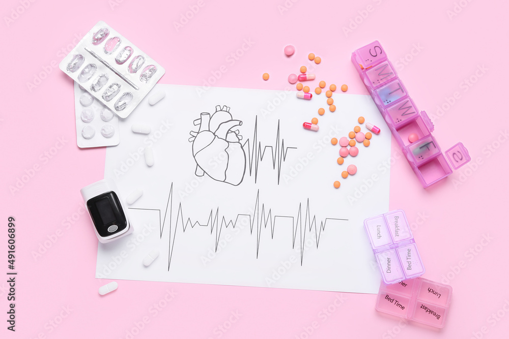 Composition with pulse oximeter, pills and cardiogram on pink background Composition with pulse oximeter, pills and cardiogram on pink background