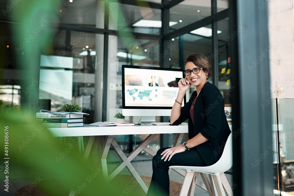 Anything is possible if youre prepared to work for it. Cropped portrait of an attractive young businesswoman sitting alone at her desk in her office. Anything is possible if youre prepared to work for it. Cropped portrait of an attractive young businesswoman sitting alone at her desk in her office.