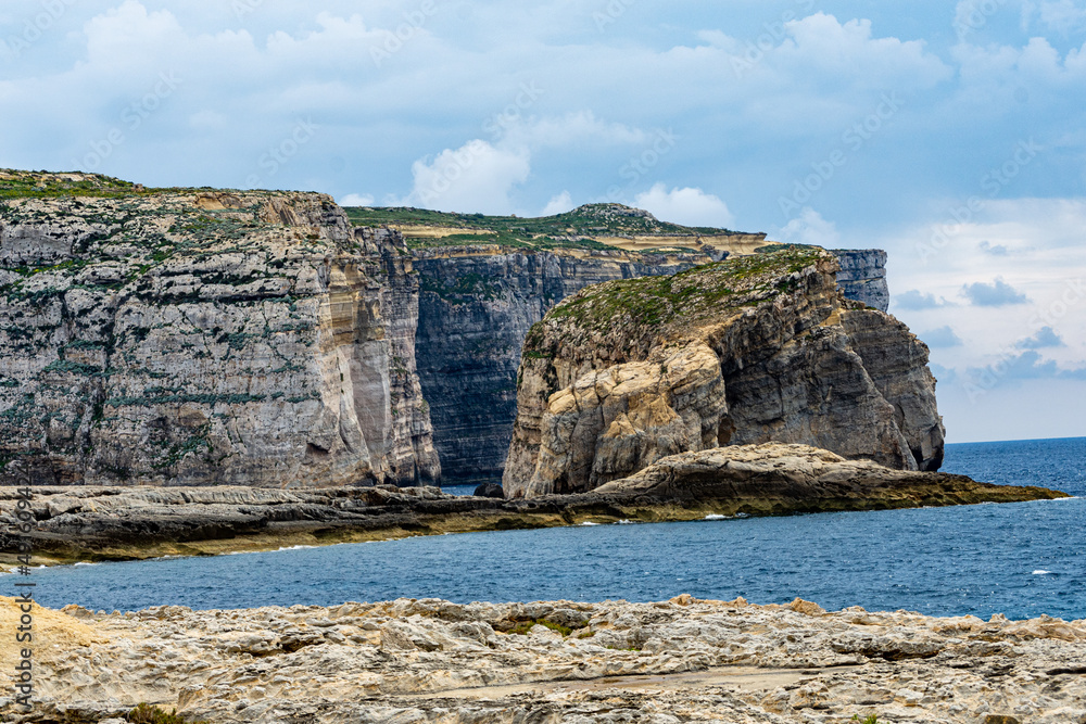 The cliffs at Dwejra Bay, Gozo, with the islet Fungus Rock aka Il-Ġebla tal-Ġeneral (The General's Rock).