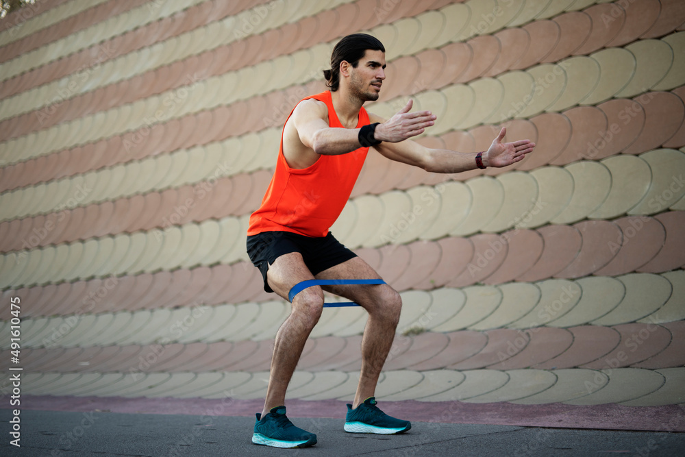 Obraz premium Young muscle man training outside. Fit handsome man doing exercise.