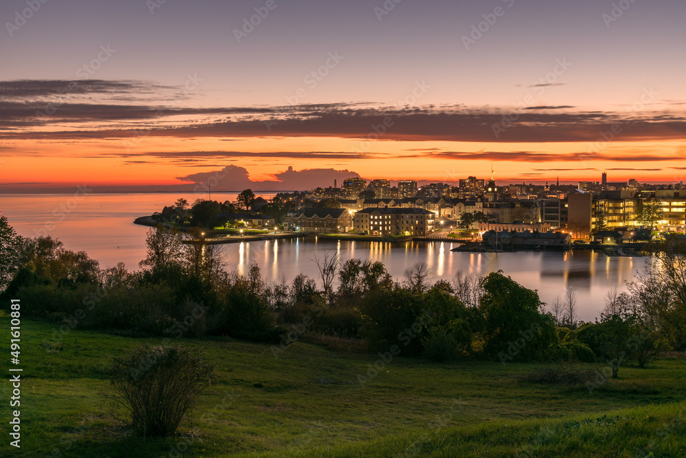 View of a city on a lake at Dusk. Reflection in water. Kingston, ON, Canada.