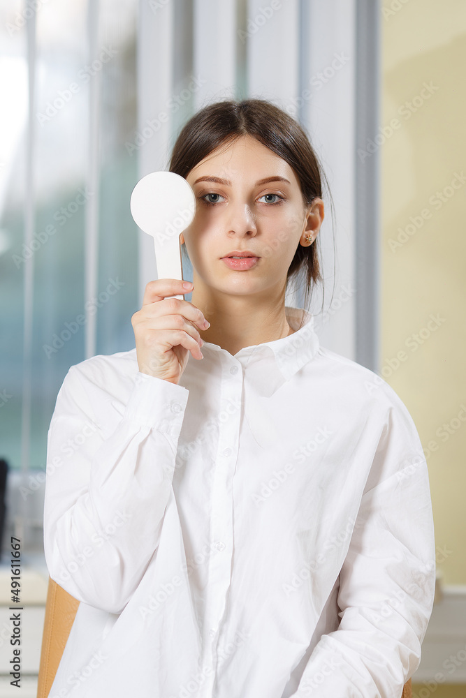 Close up portrait of a Caucasian female checking eyesight in an ophthalmologist clinic Close up portrait of a Caucasian female checking eyesight in an ophthalmologist clinic