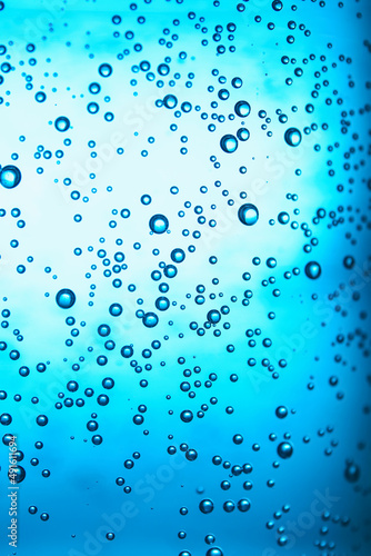 Clear water with bubbles on blue background  closeup