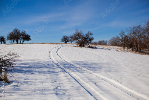 Winter Nature Landscape. Snow Covered Rural Road. Countryside Winters Scenery. Blue Sky. Hills And Fields.